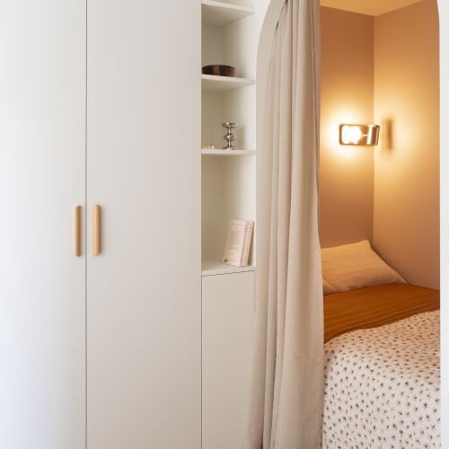 Vue d’ensemble du studio rénové avec coin nuit en alcôve, arche architecturale et circulation fluide